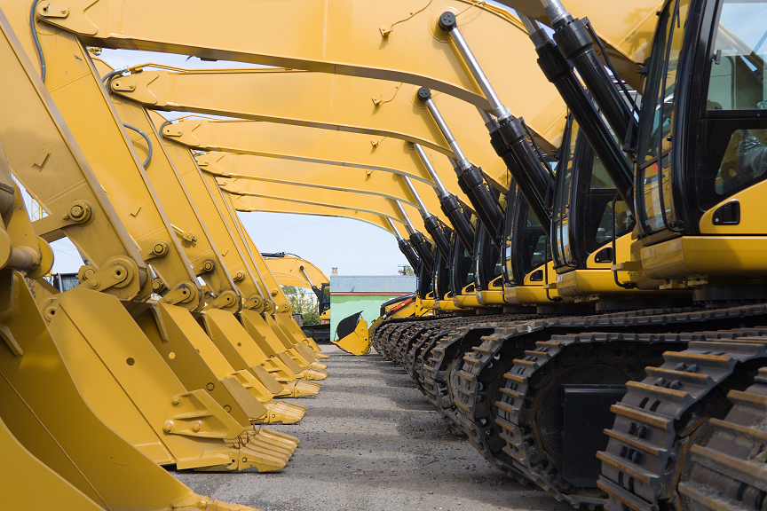 Row of heavy equipment excavators representing machine buying decisions, parts availability, and long-term ownership support