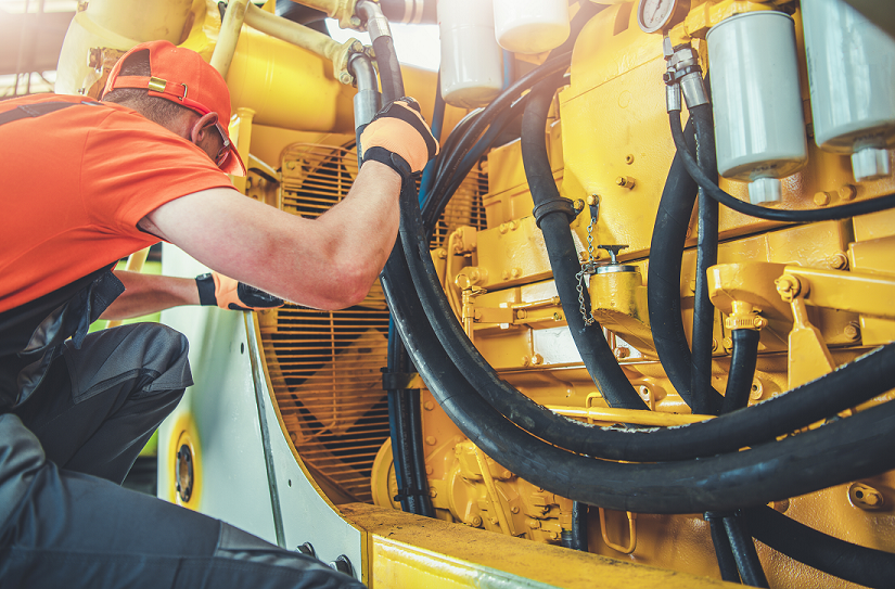 Heavy equipment repair technician using diagnostics as AI, robotics, telematics, and predictive maintenance reshape construction equipment service.